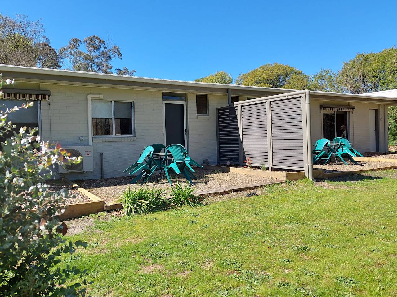Unit exteriors with chairs set out on the lawn